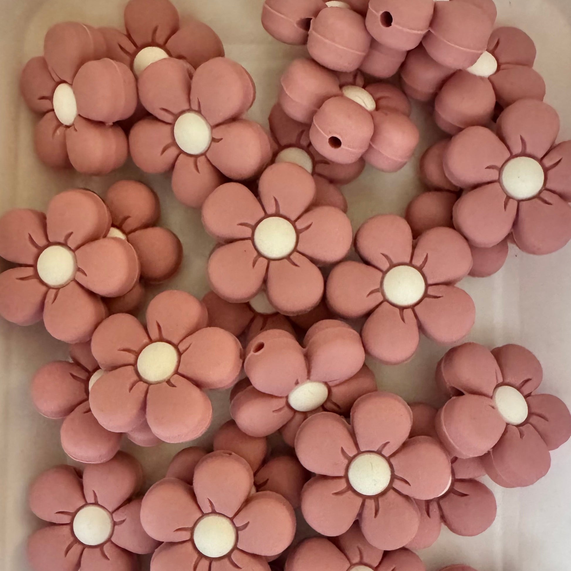 Pink flower-shaped objects on a white surface