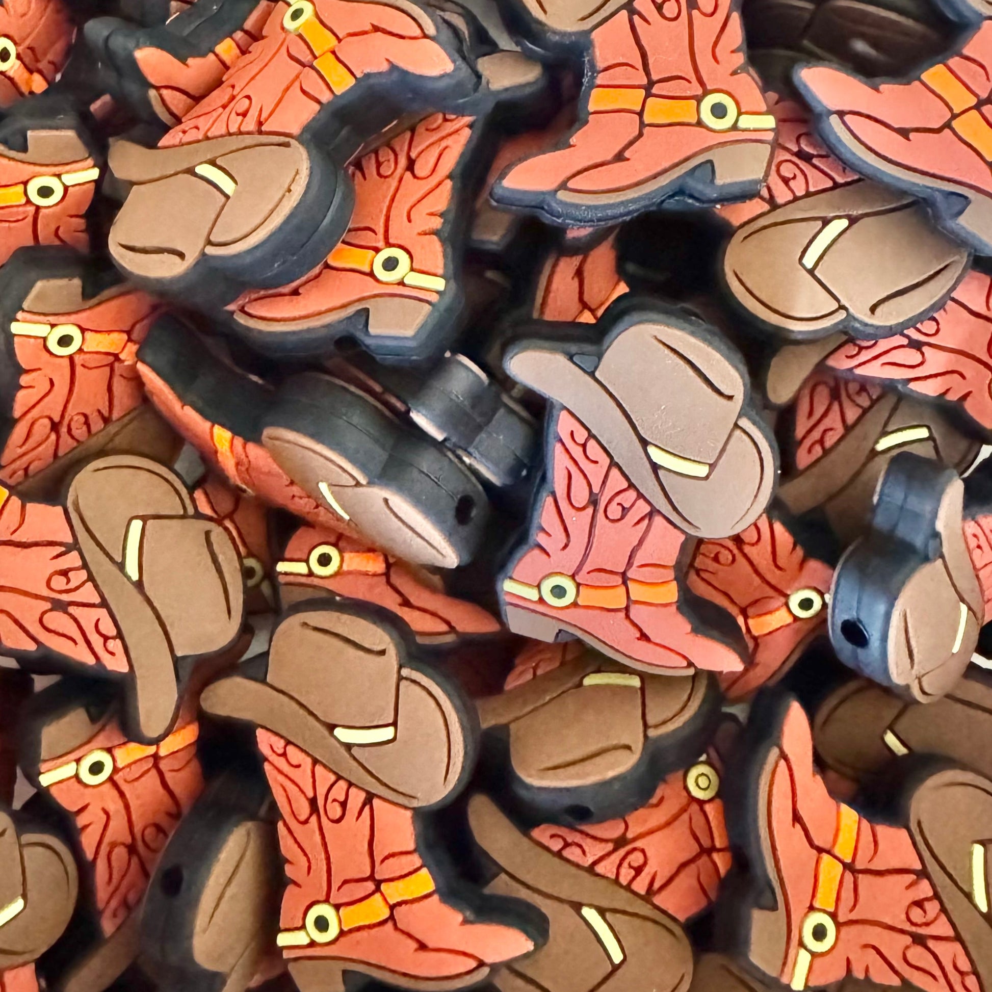 Collection of cowboy boot and hat-shaped decorations on a white background