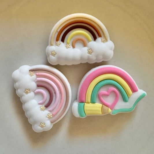 Colorful rainbow-shaped beads on a light background