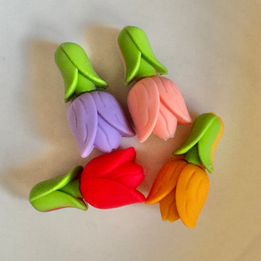 Colorful tulip-shaped erasers on a beige background