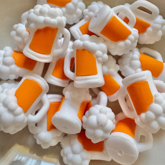 Collection of white and orange plastic beads on a light background