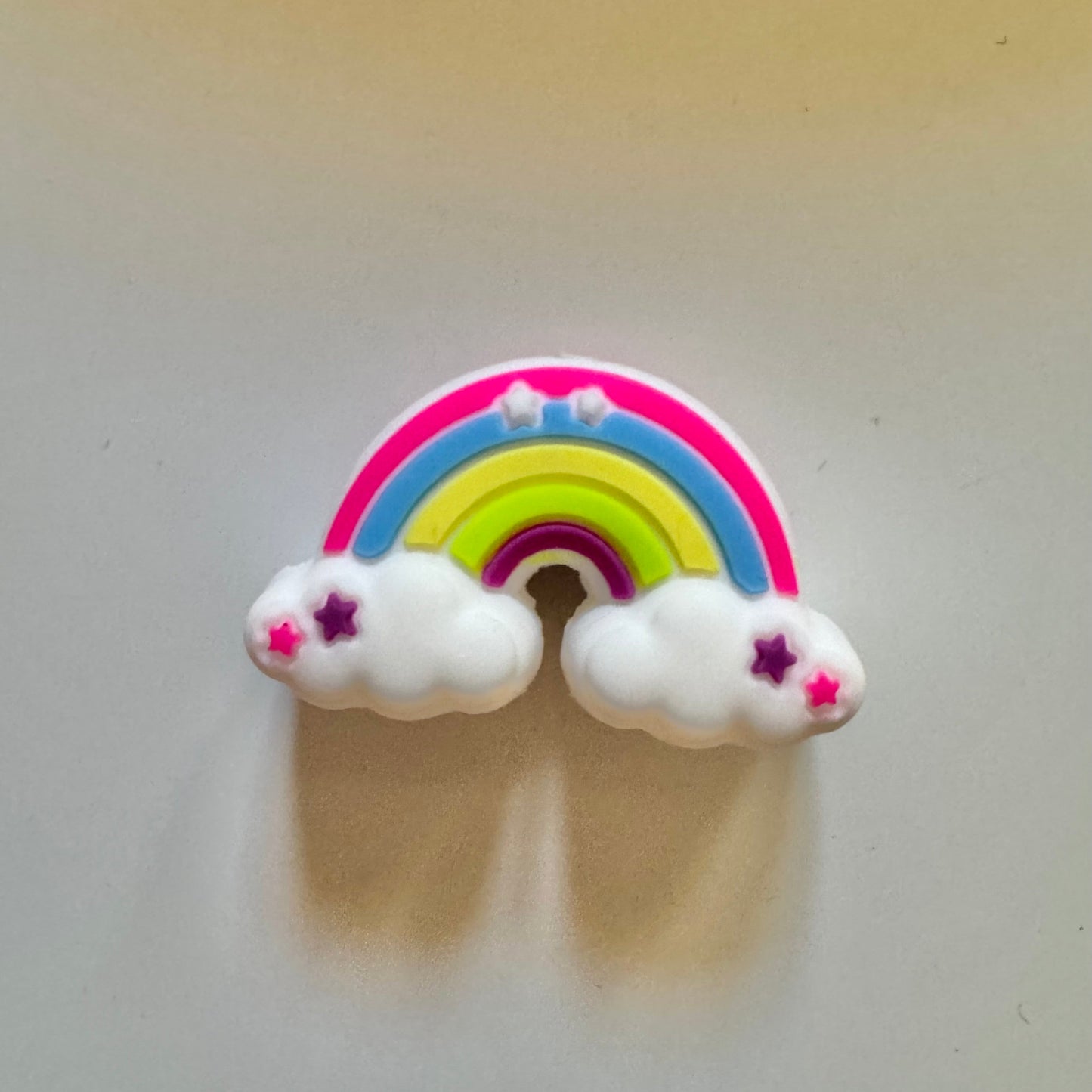 Colorful rainbow and cloud design on a plain background