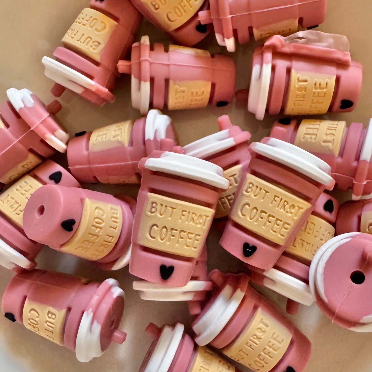 Pink and gold coffee cup-shaped objects on a light surface