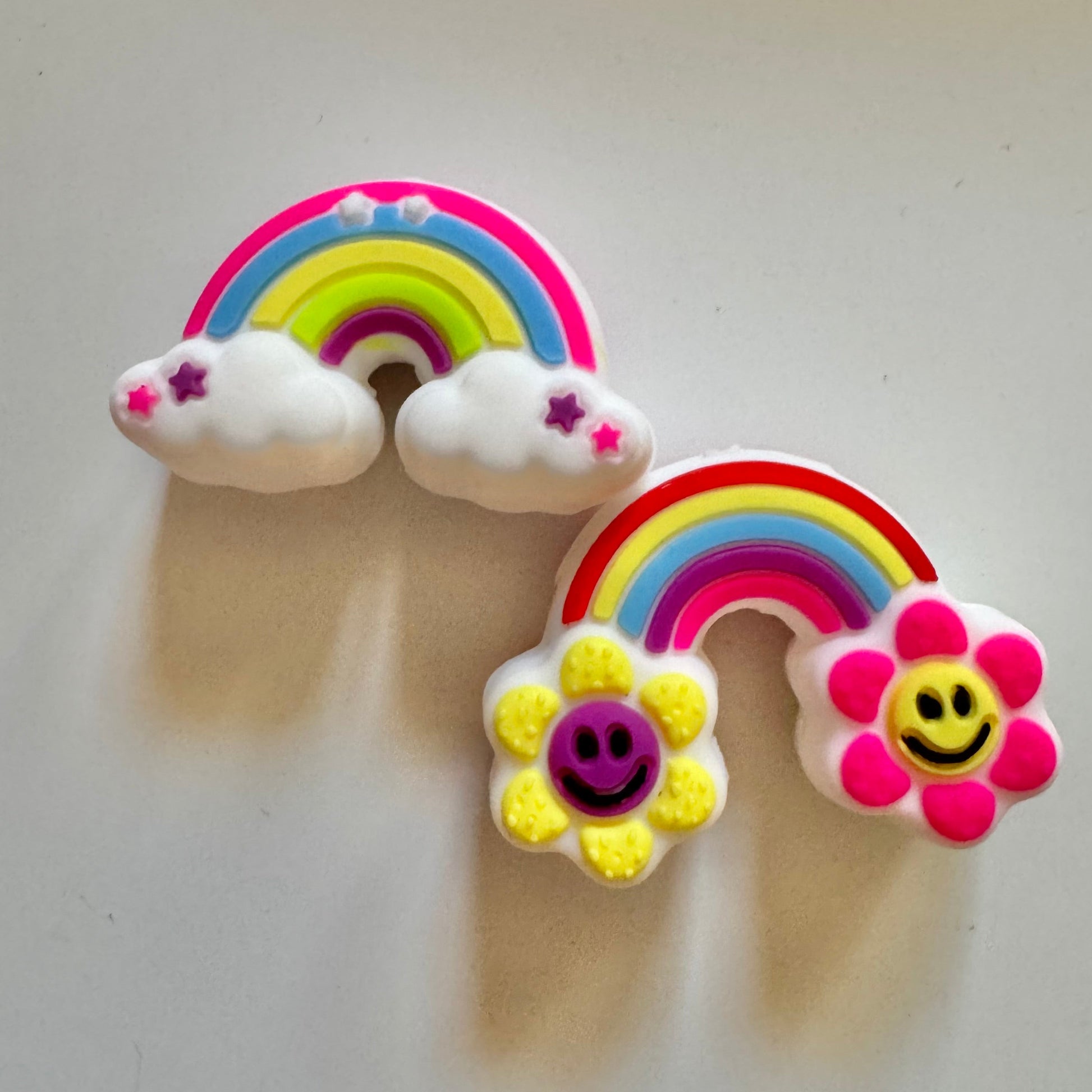 Colorful rainbow and cloud-shaped beads on a light gray background