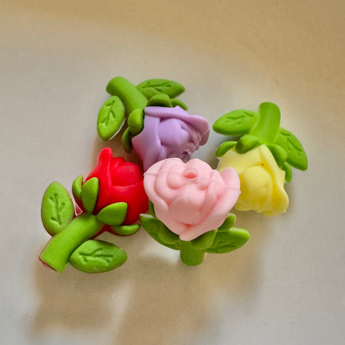 Colorful flower-shaped hair clip on a reflective surface