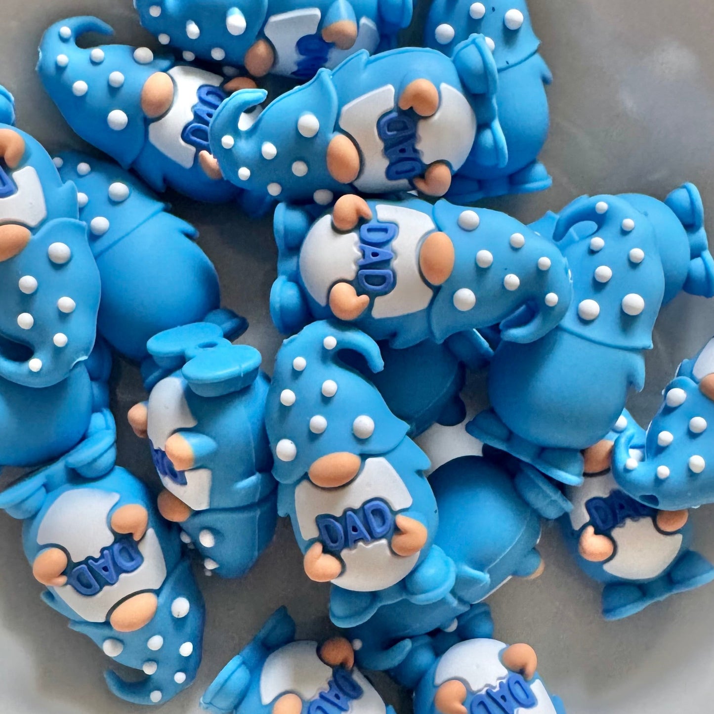 Blue gnomes with 'Dad' text on a white surface